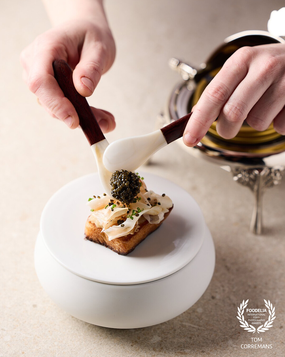 A lukewarm brioche with compote of Cévennes onion, guanciale and Imperial Heritage caviar. Shot at restaurant Hédoné, Tongeren, Belgium.