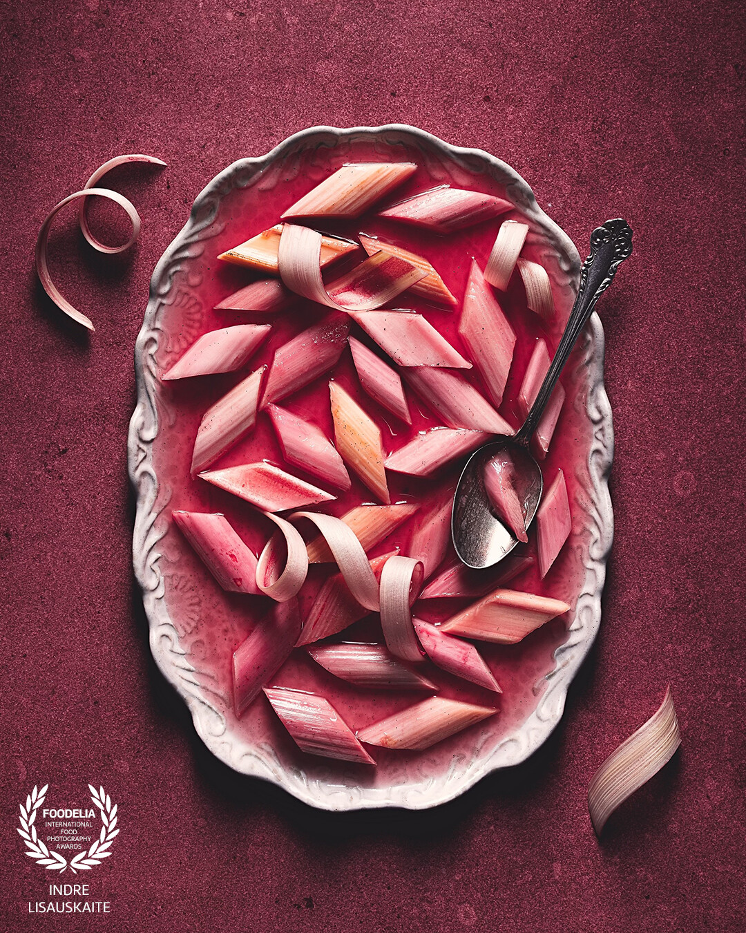 A study in texture, tone, and shape—this image turns simple rhubarb into a piece of edible art. The rich monochrome palette and moody lighting create a painterly, almost surreal atmosphere, while the clean styling and geometric cuts give it an editorial edge. It’s romantic, dramatic, and unmistakably refined.