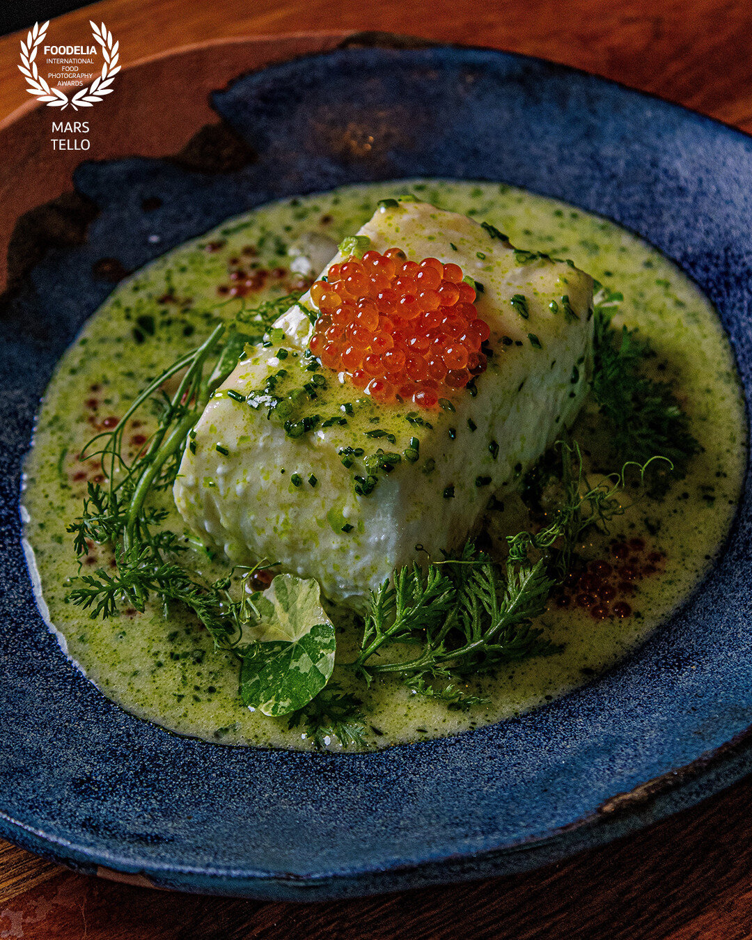 the iconic halibut from this Michelin star rated restaurant is prepared using ambient heat; it's gently rubbed in oil and rested high above the flames of the grill, gently rotated to achieve an even cook. It absorbs additional flavors from the fats and sugars caramelizing from the proteins on the direct flame two feet below.