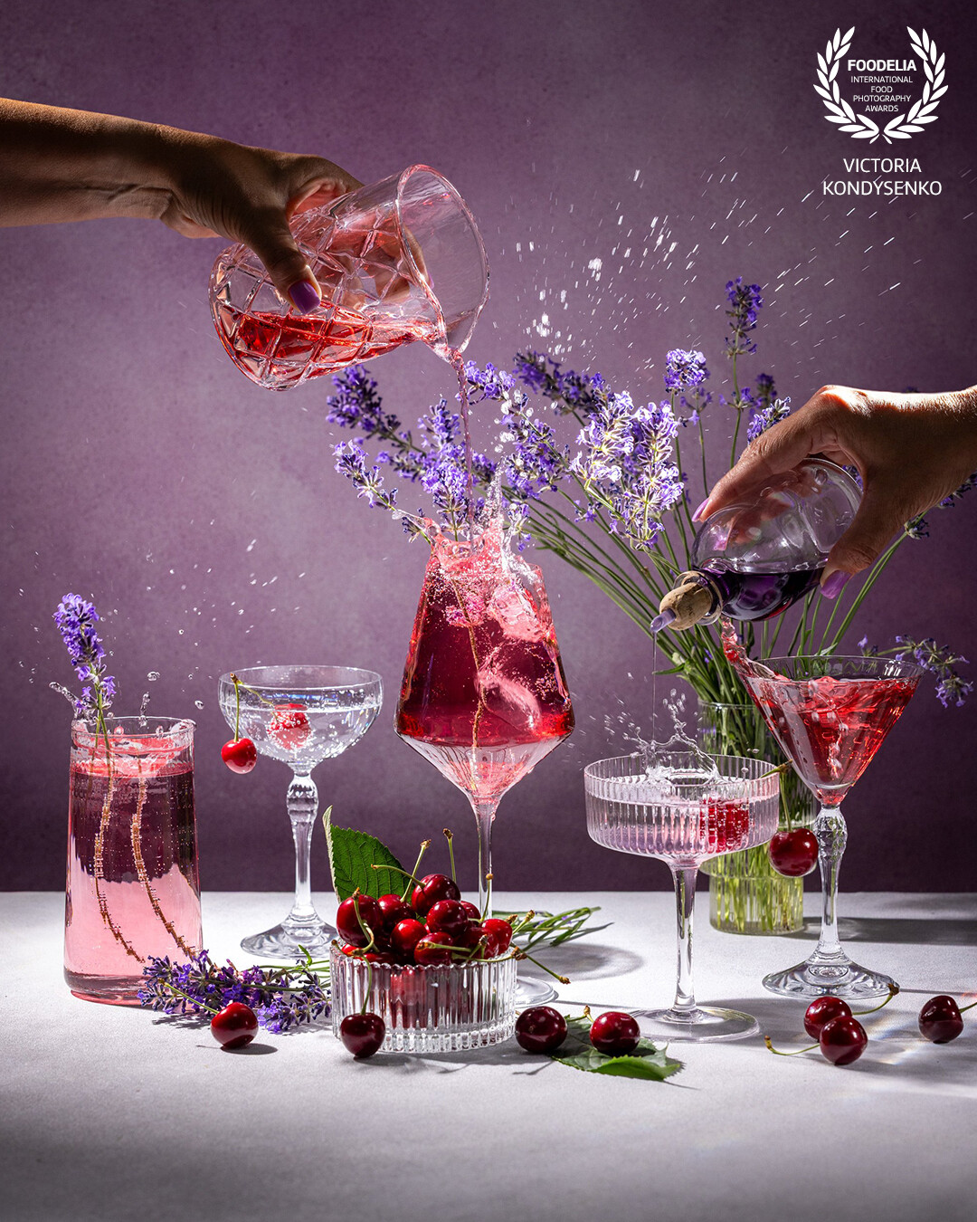 Mix of different glasses with summer cherry and lavender cocktails. A summer evening with the aroma of a sun-warmed garden.