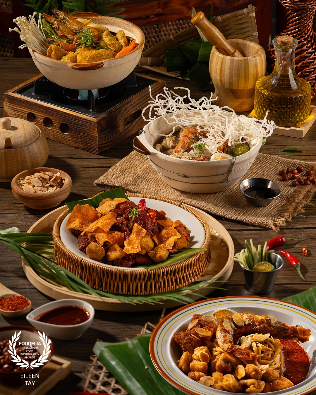 This vibrant overhead scene showcases beloved Malaysian dishes with thoughtfully chosen traditional props. The composition captures the abundance and warmth of a communal meal, emphasizing texture, color, and variety.