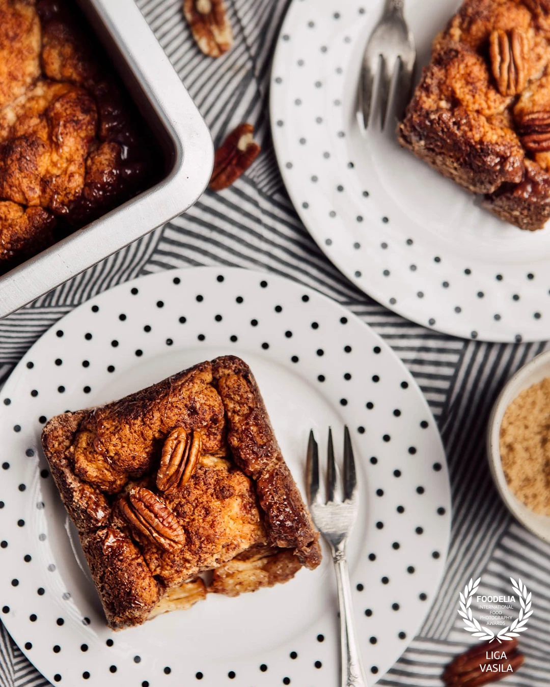 A table setting featuring served Pecan Monkey Bread, which combines textures, layers, and geometric shapes.