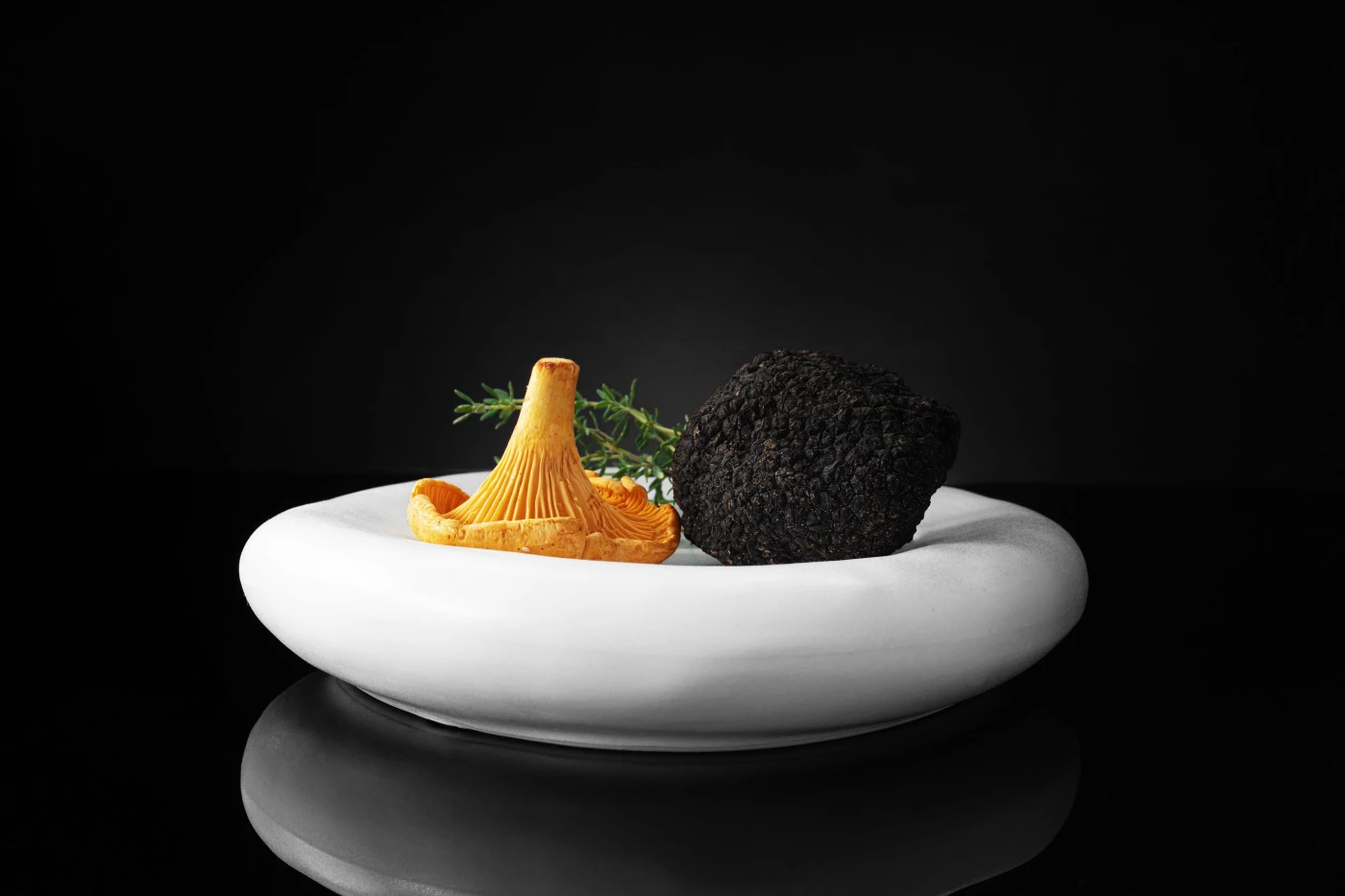 A black truffle and a seasonal golden chanterelle, placed together in my signature minimal compositi...