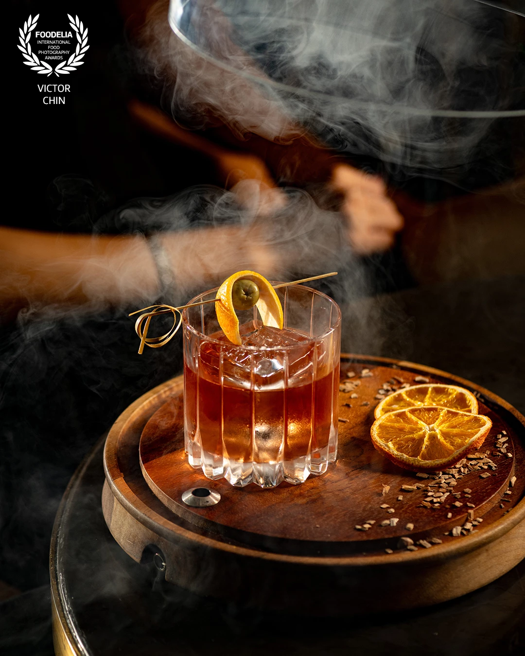 Honoured to have this image recognized. Captured for Gordon Ramsay Bar & Grill Malaysia, this shot was about showcasing the cocktail’s sophistication through light, texture, and atmosphere. I used a few strobe lights to shape the glass and enhance the smoke’s movement, creating depth and drama around the drink.<br />
<br />
The warm tones and reflections were refined in Adobe Lightroom, bringing out the amber glow of the cocktail while keeping the mood rich and cinematic. My goal was to highlight the craftsmanship and luxury behind every detail of the drink.
