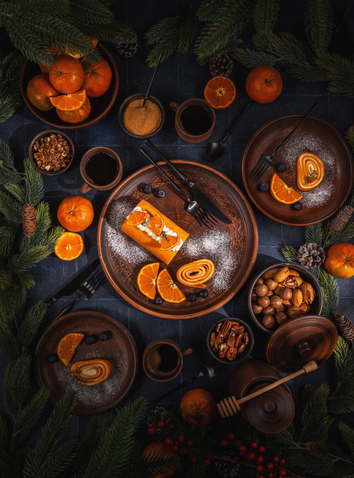 Holiday flat lay arrangement with a delicious cream roll cake topped with tangerines, blueberries, a...