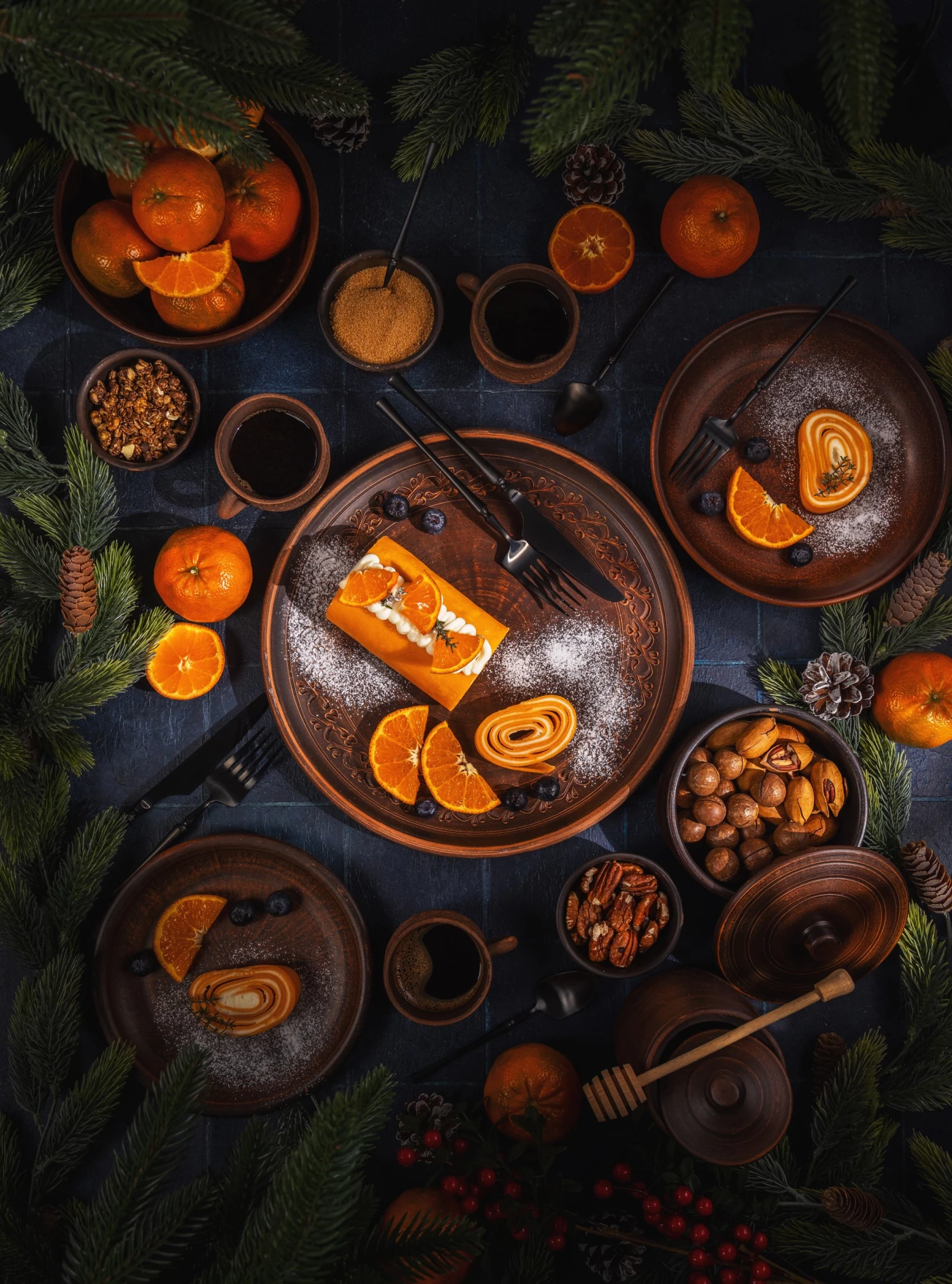Holiday flat lay arrangement with a delicious cream roll cake topped with tangerines, blueberries, a...