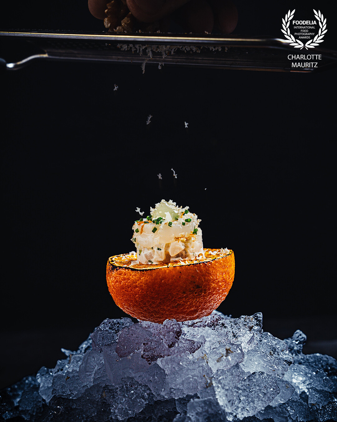 Scallops on a tangerine and ice with shaved walnuts. Part of the menu of high end caterer famous flavours