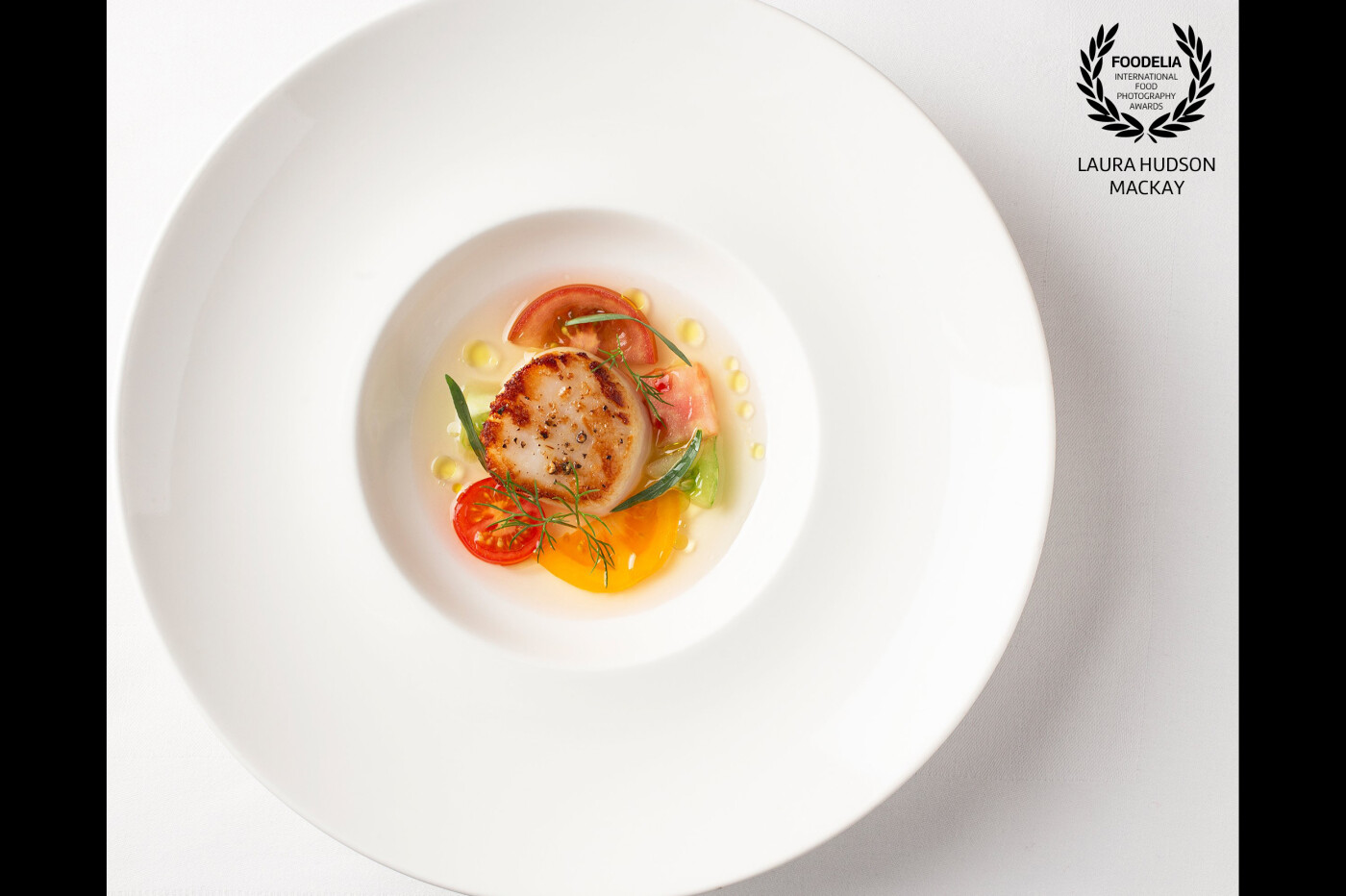 Pan Seared Skye Sea Scallop, with Heirloom Tomato Consommé, Garden Herbs and Olive Oil <br />
<br />
Photoshoot of a delicious dish presented by Chef Tony Pierce at Knockinaam Lodge, Portpatrick, Scotland.