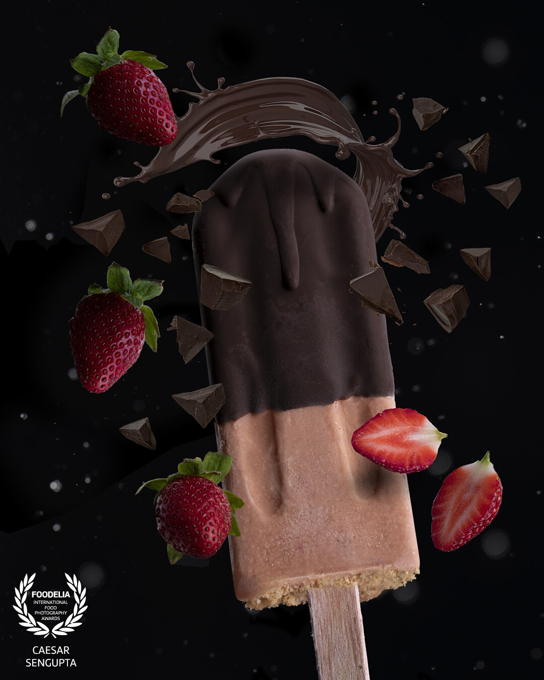 A dark and moody levitation image. The strawberries and the popsicle are shot differently and then merged to make a composite image.