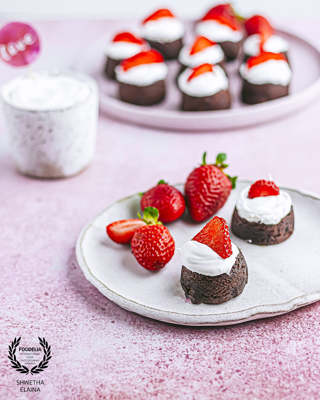 Gluten-free vegan brownie bites topped with whipped coconut cream and fresh strawberries  are perfect for a romantic dessert or just because you deserve it !