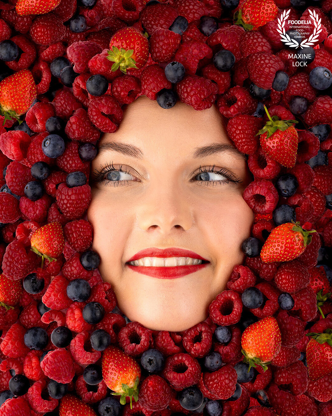 A face embodied within a sea of berries.